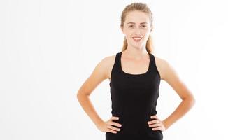 Happy young woman in sports clothing smiling. Fitness model on white background looking at camera at copy space. photo