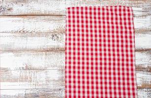 checkered tablecloth on old wooden table, holiday concept photo