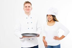 smile black female and white male chefs cooks hold an empty tray isolated on white background