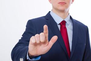 Stylish Business man point on virtual screen isolated on white background. Selective focus of pointing finger photo