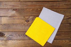 yellow and grow napkins on old wooden table, food drink concept, mock up photo