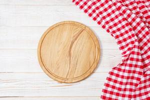 Top view wrinkled red tablecloth and plank on wooden table, mock up photo