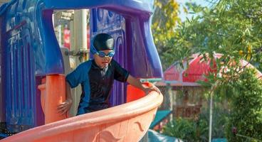 Children frolic at the water park. It is a sunny, perfect day for getting wet and playing hard photo