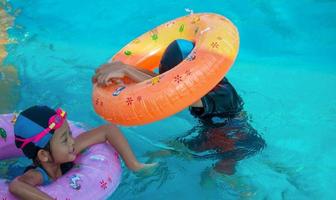 Children frolic at the water park. It is a sunny, perfect day for getting wet and playing hard. photo