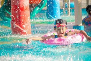 Children frolic at the water park. It is a sunny, perfect day for getting wet and playing hard. photo
