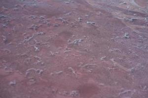 Background texture sea pink salt. Salt crystals close up. Pink salt lake. photo