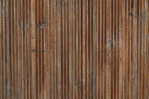 Vintage texture of wooden, vertical bars, knocked down together. Old, screw door. The web is of natural material. Decorative covering of wooden thin bars