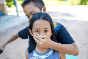 A boy and a girl play a hostage attacker. photo