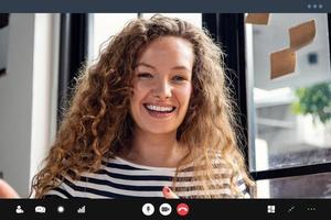 Happy pretty Caucasian woman smiling at the camera while making video call at home photo