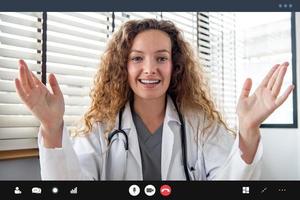 Young Caucasian woman doctor explaining patient via video call, home medical online consulation service concepts photo