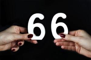 To female hands the number sixty-six. photo