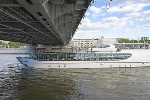 The ship sails under the bridge on the Moscow river. photo