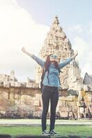 Young attractive woman enjoy life while traveling at phnom rung temple in thailand. photo