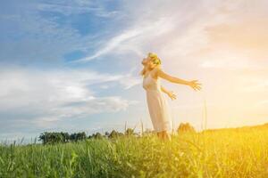 Freedom concept  Young beautiful woman enjoying with fresh air and nature at meadows. photo