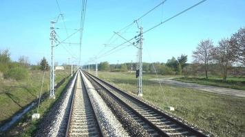 tren de alta velocidad moviéndose en ferrocarril a la ciudad a través del bosque y el campo, día 4k video