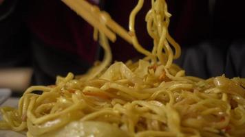 Man eating Chinese Noodles With Vegetables With Chopsticks, Fast Food Restaurant video