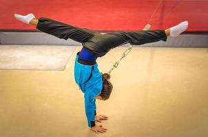 Young gymnast girl practicing handstand photo