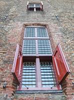 Red shutters on old castle window