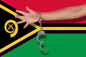 handcuffs with hand on Vanuatu flag photo