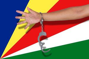 handcuffs with hand on Seychelles flag photo