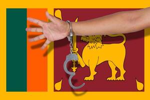 handcuffs with hand on Sri Lanka flag photo