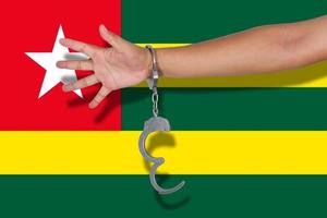 handcuffs with hand on Togo flag photo