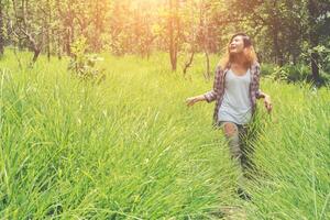 Young woman enjoying nature in the middle of a meadow, Freedom and relaxing. photo