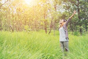 Young woman enjoying nature in the middle of a meadow, Freedom and relaxing. photo