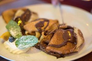 Sweet French crepe with chocolate cream photo