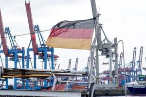 German flag waving in the port of Hamburg Germany photo