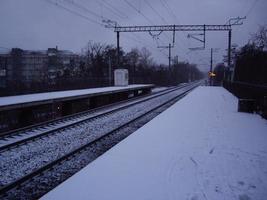 Snow-covered railway platform in the morning in winter photo