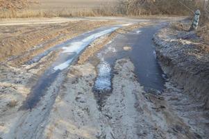 Forest frozen road with ice and snow photo