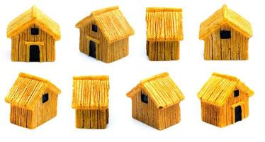 The concept of a mortgage. Wooden house model on white background, close-up photo