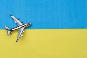 Flag of Ukraine and the plane. The concept of travel. photo