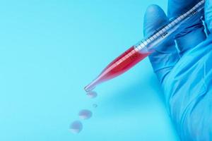 Hands of clinician holding tools during scientific experiment in laboratory photo