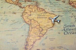 Airplane over the map of South America. photo