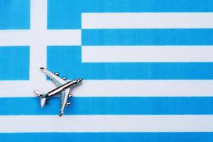 Flag of Greece and the plane. The concept of travel. photo