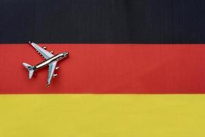 The flag of Germany and the plane. The concept of travel. photo