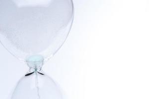 Hourglass on white background. Sand falls inside the flask. photo