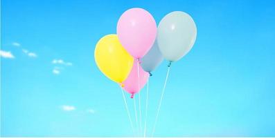 Flying coloured balloon on blurred sky background photo