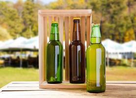 craft beer in wooden box on blurred background of summer pub area photo