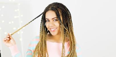 Portrait of beautiful positive african american black woman standing and spinning hair Copy space. photo