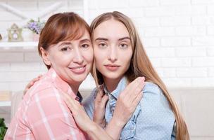 Happy family. Macro women faces at home background. Mother and daughter. Mothers day. photo