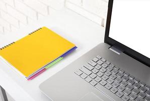 Workspace with computer and notebook. Copy space and top view. Selective focus photo