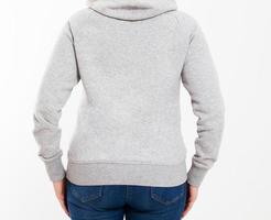 Girl in a gray sweatshirt with a hood and an empty space for a logo isolated close up photo