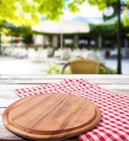 pizza desk,tablecloth on wooden table on blurred restaurant background, holiday concept photo