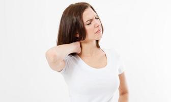 Tired brunette woman having pan in neck isolated on white background photo