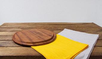 pizza desk, yellow grow napkins on empty wooden table, copy space photo
