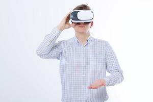 Young business man in vr glasses, goggles watching virtual reality isolated on white background. Copy space and mock up photo