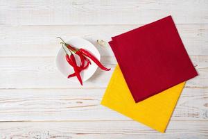 top view coloured napkins and hot peper on table,copy space photo